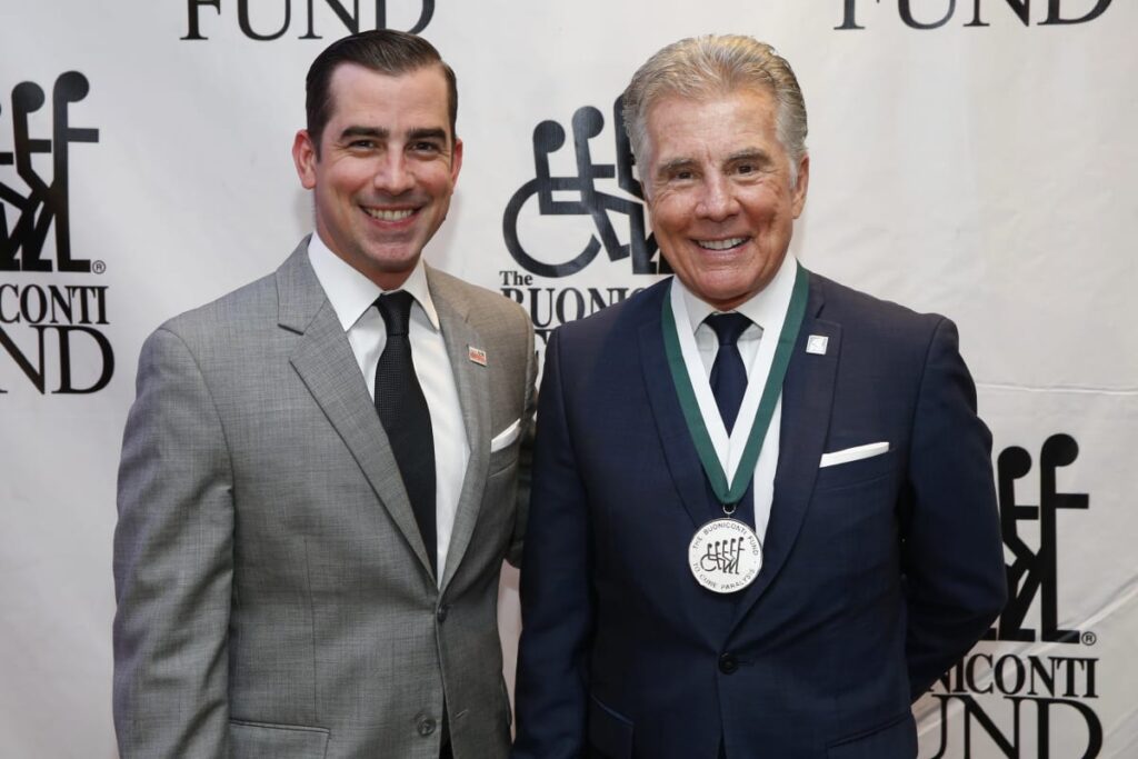 Callahan Walsh (L) and John Walsh (R) attend the 32nd Annual Great Sports Legends Dinner To Benefit The Miami Project/Buoniconti Fund To Cure Paralysis