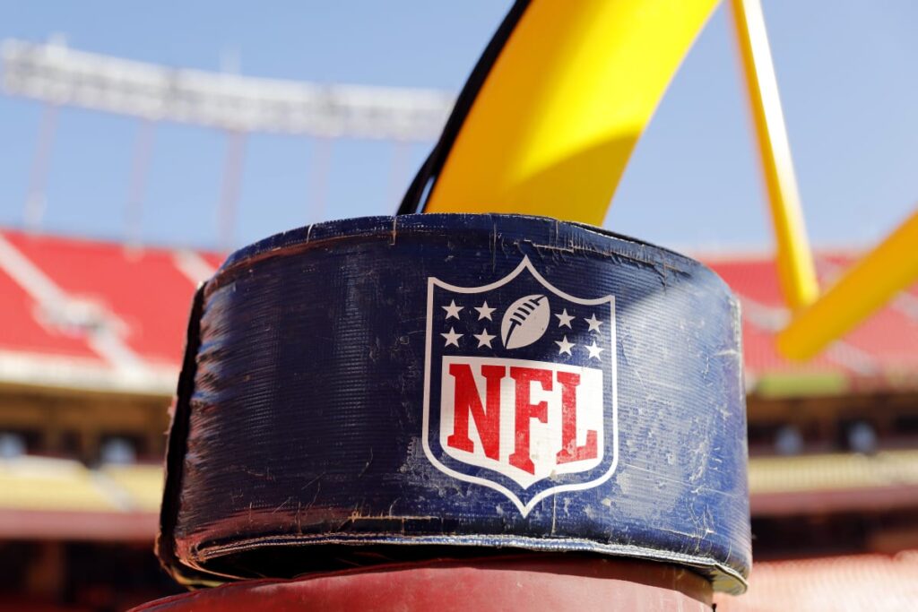 A detail view of the NATIONAL FOOTBALL LEAGUE logo on the goal post 