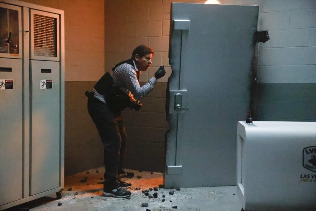 Beau Finado examines a door - CSI: Vegas