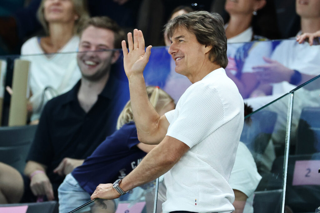 Tom Cruise waves during the Artistic Gymnastics Women's Qualification on day two of the Olympic Games Paris 2024 at Bercy Arena on July 28, 2024 in Paris, France. 