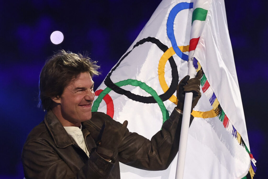 Tom Cruise waves the Olympic flag during the closing ceremony of the Paris 2024 Olympic Games at the Stade de France, in Saint-Denis, in the outskirts of Paris, on August 11, 2024. 