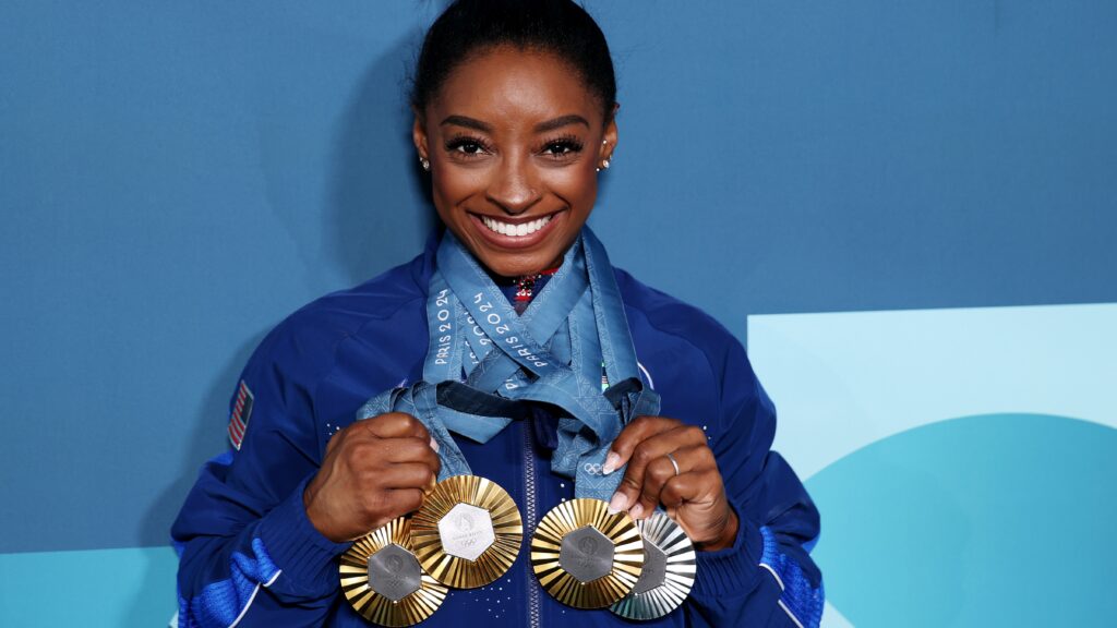 Simone Biles of Team United States poses with her Paris 2024 Olympic medals following the Artistic Gymnastics Women's Floor Exercise Final on day ten of the Olympic Games Paris 2024 at Bercy Arena on August 05, 2024 in Paris, France.