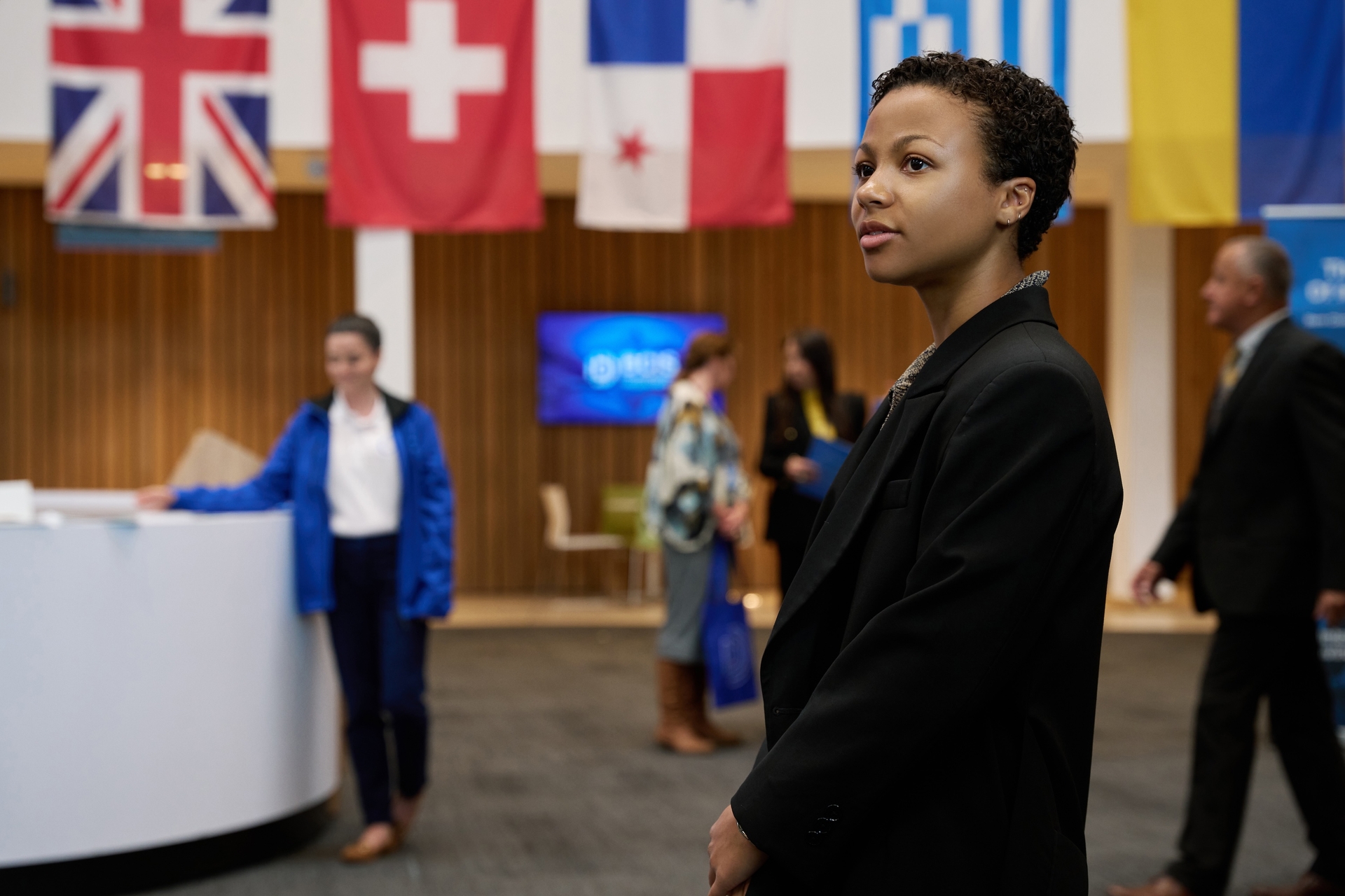 Harper arrives at a panel on Industry Season 3 Episode 3.