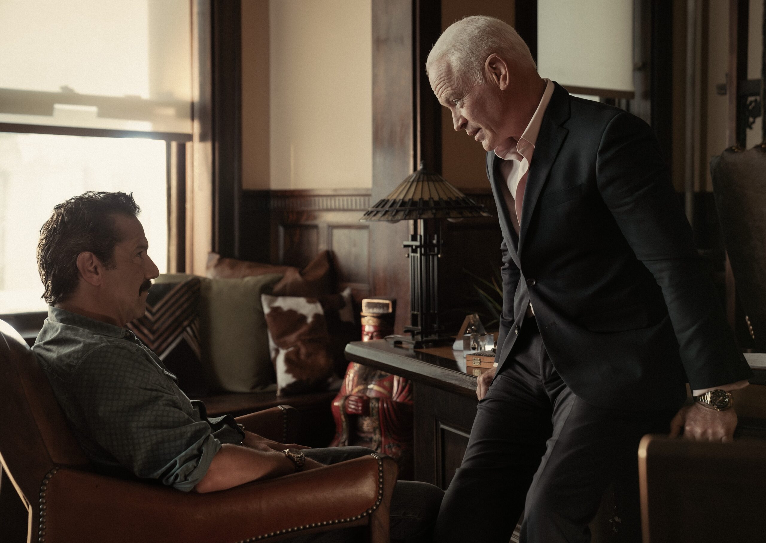 two men talking at a desk