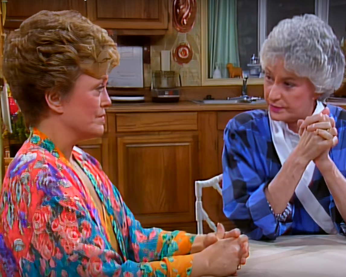 Blanche and Dorothy wearing colorful clothes at the kitchen table