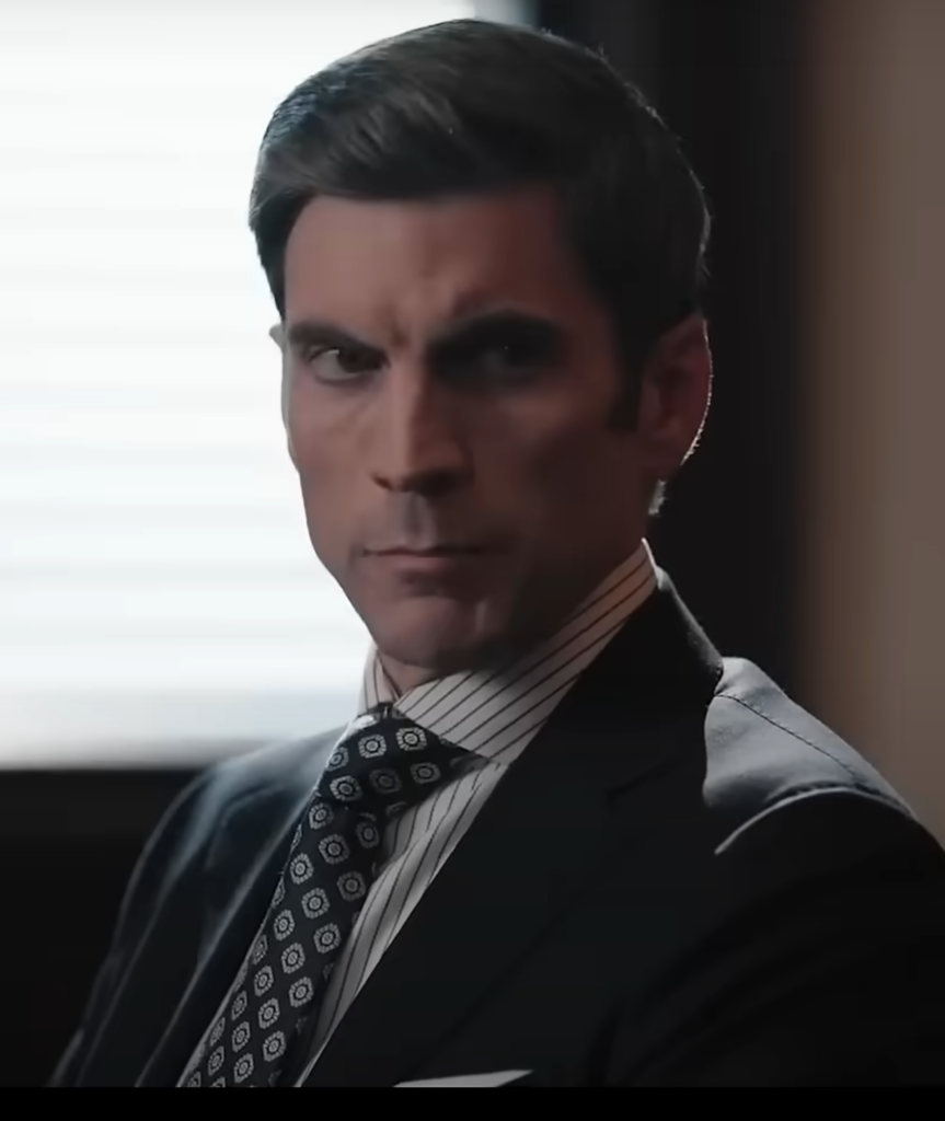 Jamie sitting at a desk wearing a polka dot tie on Yellowstone Season 5 Episode 10