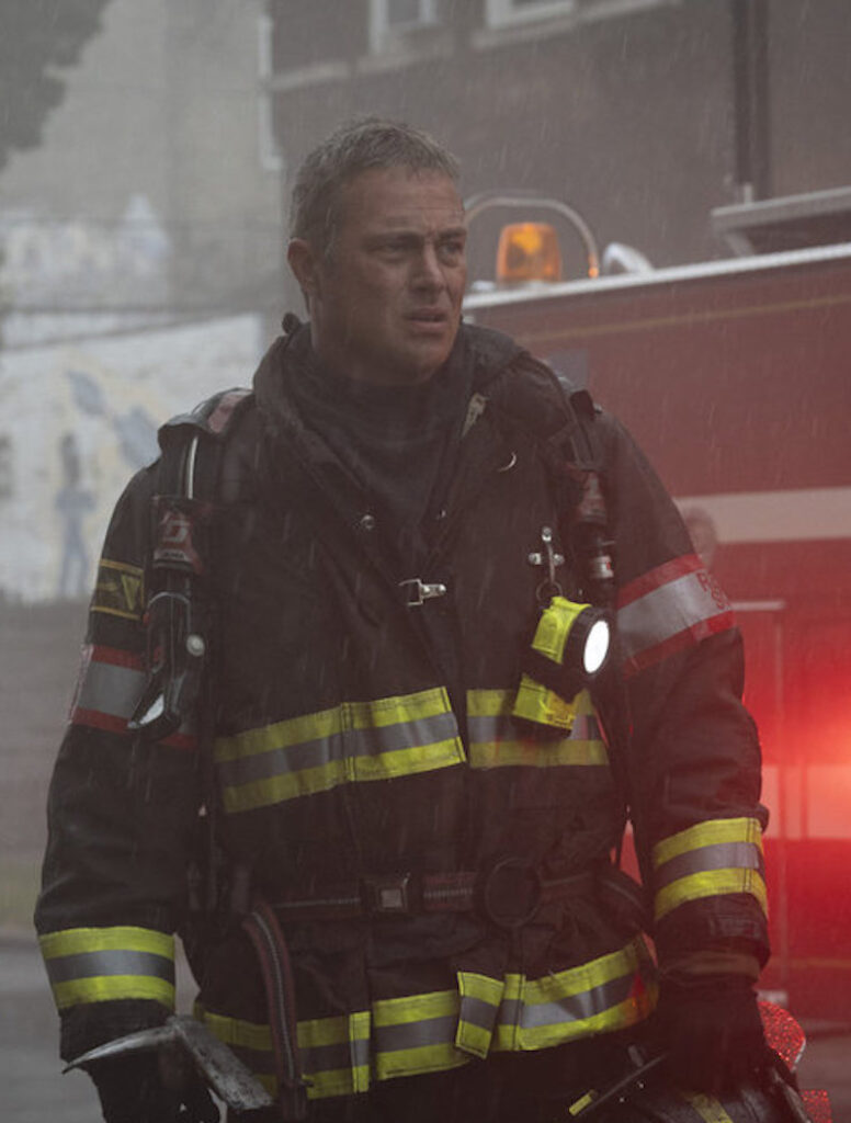 Severide in the rain on a call.