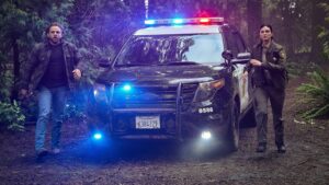 Max Thieriot as Bode Leone and Morena Baccarin as Sheriff Mickey Fox