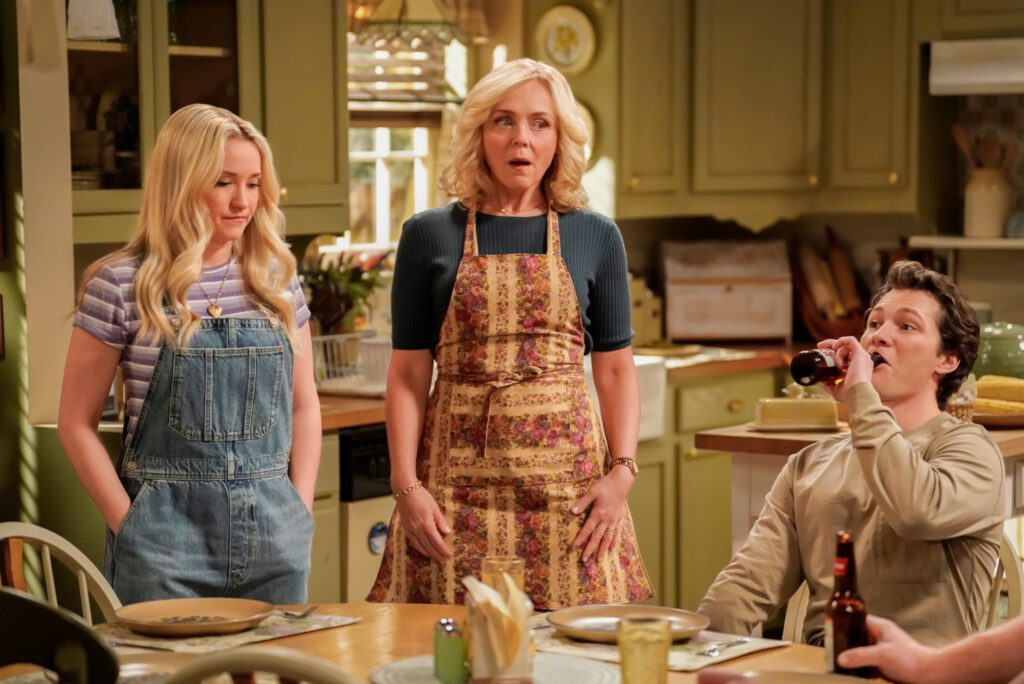 Audrey and Mandy in the kitchen looking shocked while Georgie drinks a beer on Georgie & Mandy's First Marriage Season 1 Episode 15