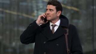 man in a suit and peacoat