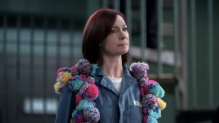 Elsbeth wearing yarn pom-poms over her jail uniform on Elsbeth Season 2 Episode 20