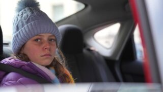 Haley looks out from the back seat of a car shortly before she is kidnapped on Law & Order: SVU Season 26 Episode 19.