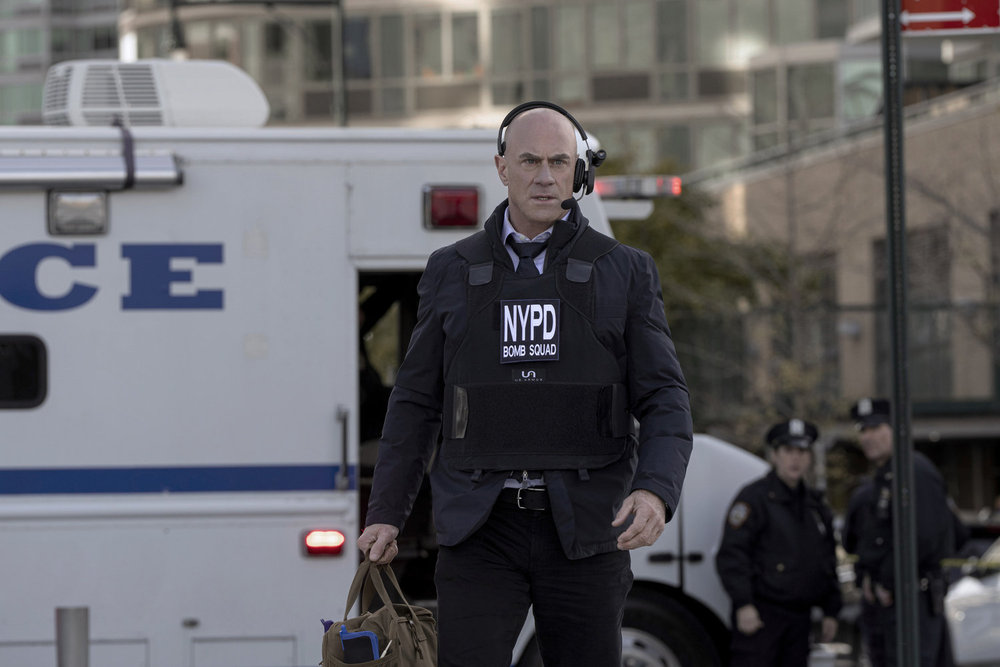 Stabler wearing a Bomb Squad vest and talking into a headset on Law & Order: Organized Crime Season 5 Episode 8