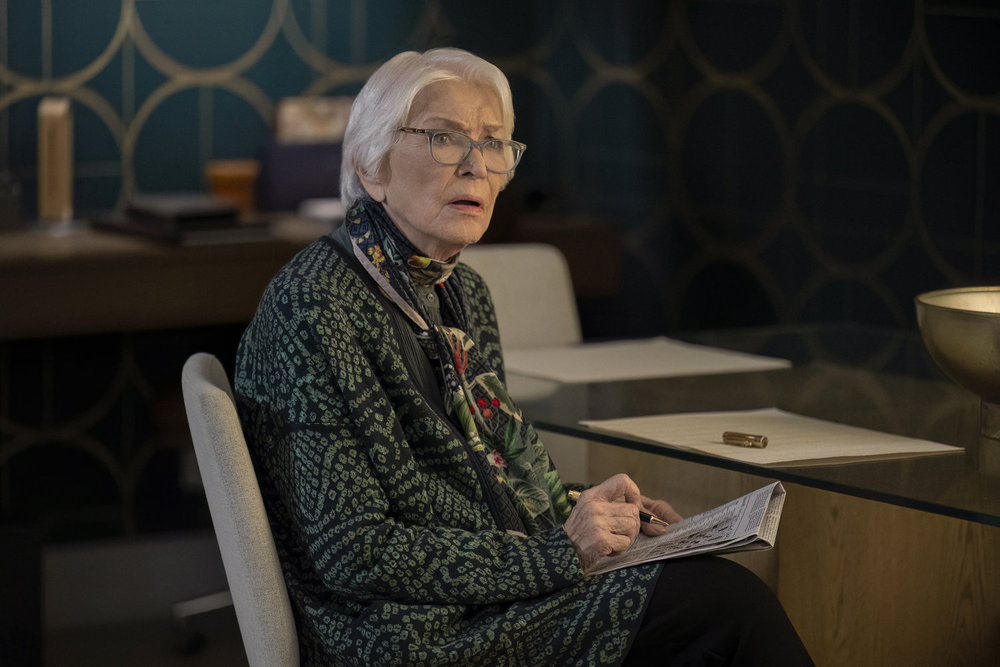 Bernie knows she is being lied to as she does a crossword puzzle on Law & Order: Organized Crime Season 5 Episode 9