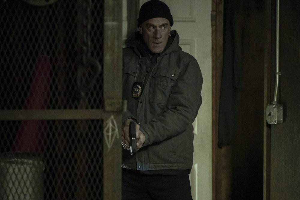 Stabler draws his gun during a raid on Law & Order: Organized Crime Season 5 Episode 10