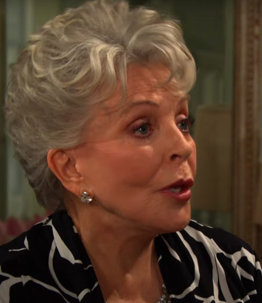 Julie looking off-camera and talking on Days of Our Lives during the week of 7-21-25