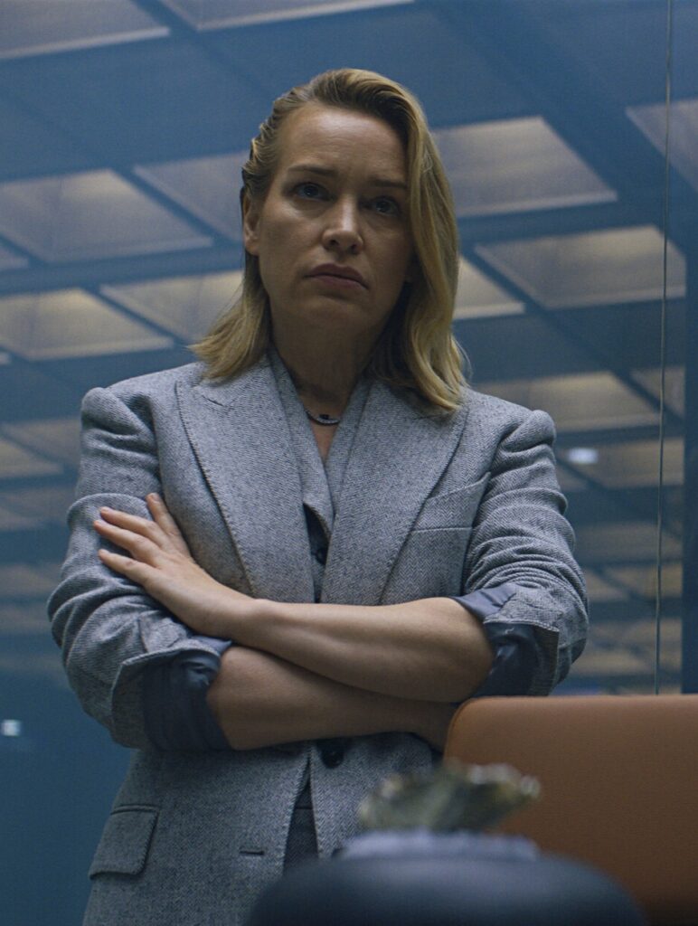 Piper Perabo standing in a power pose  wearing a suit as Juno in Butterfly