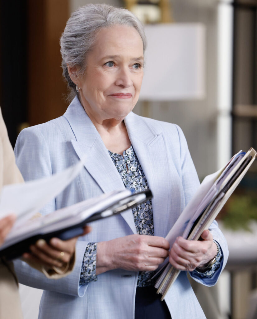 Mattie holds a folder and smiles on Matlock Season 2 Episode 1