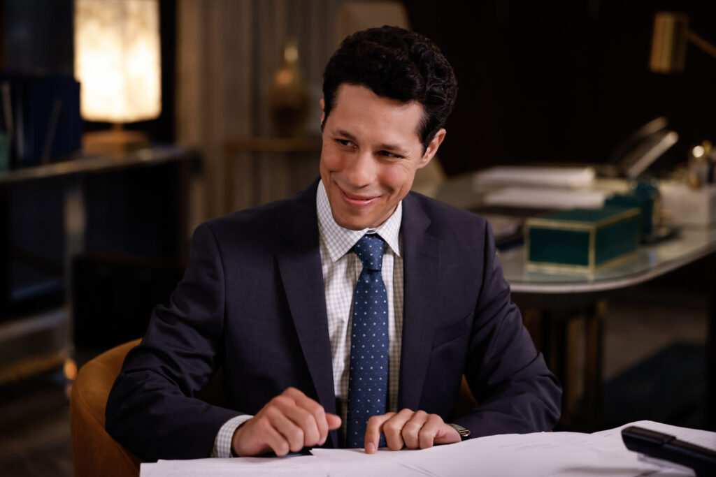 Billy smirks while working at his desk on Matlock Season 2 Episode 1