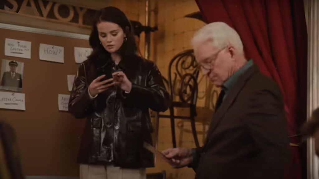 Mabel looks at something on her phone while Charles examines a different clue on Only Murders In The Building Season 5