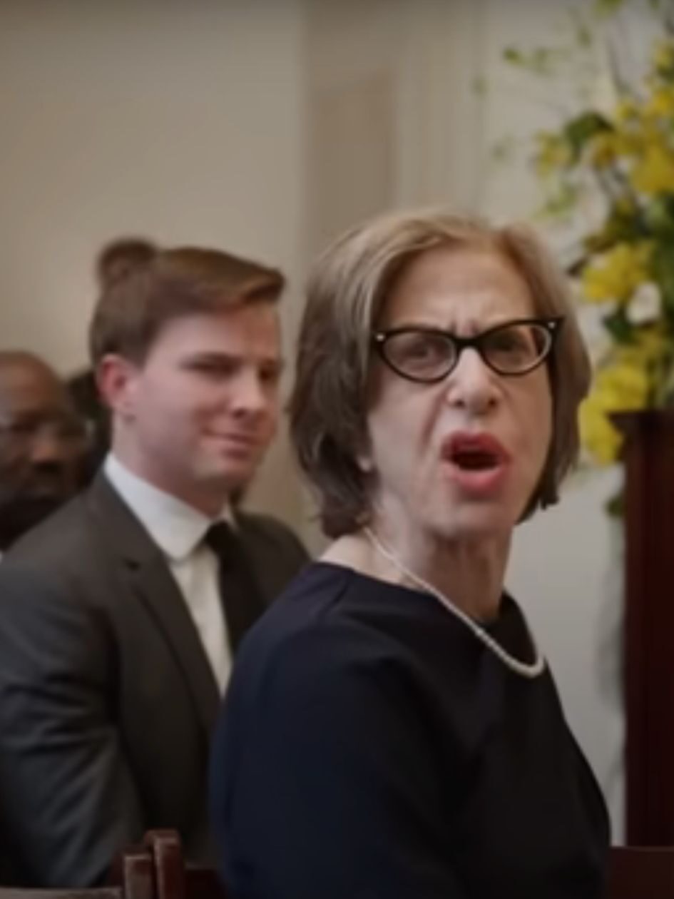 Uma gives Charles a disgusted look during the funeral on Only Murders In The Building