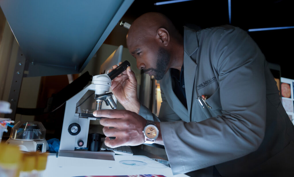 Watson checks genomes using a microscope on Watson Season 2 Episode 3