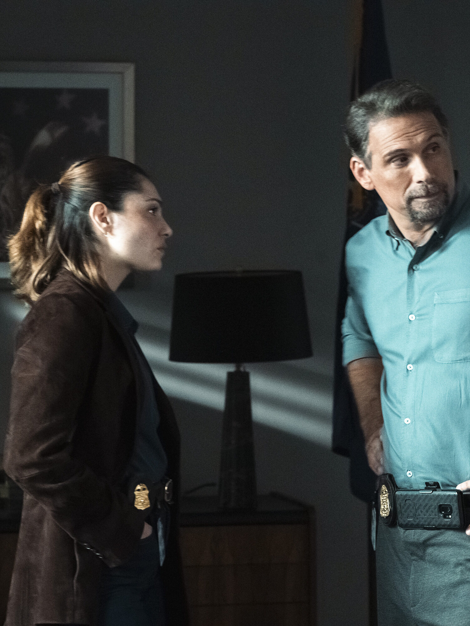 Jubal and new agent Eva Ramos discuss the case n a darkened room on FBI Season 8 Episode 3