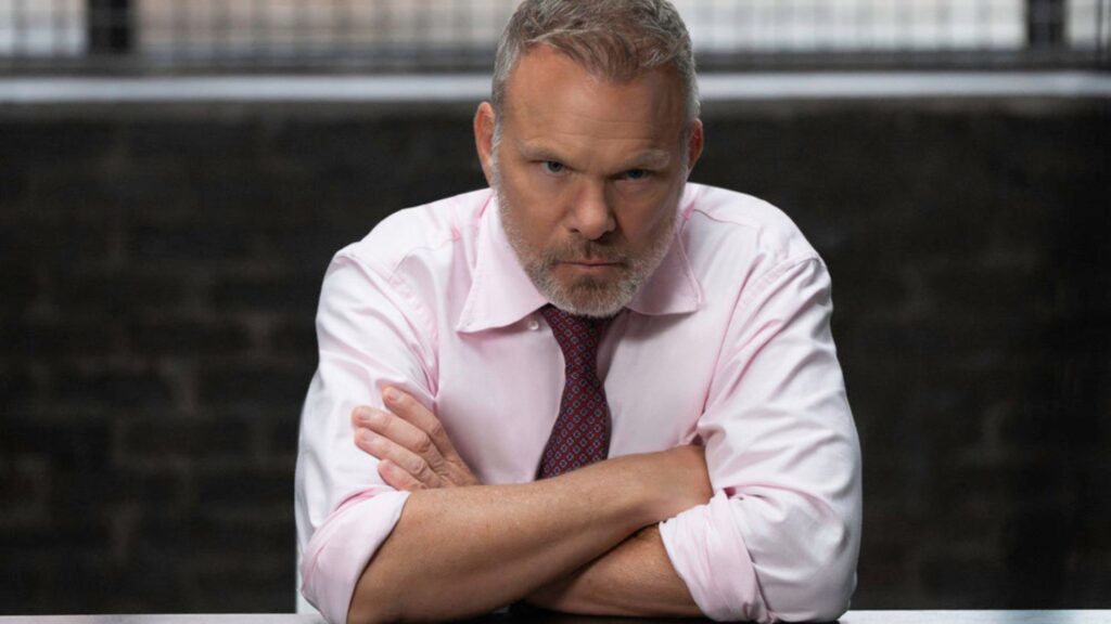 A man on the defensive with his arms crossed on Law & Order: SVU Season 27 Episode 3