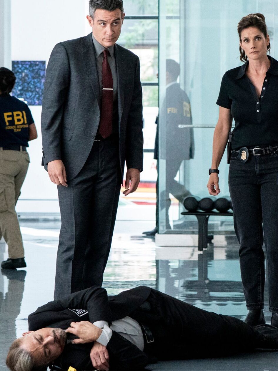 Scola and Maggie stand in front of a dead security guard on FBI Season 8 Episode 2