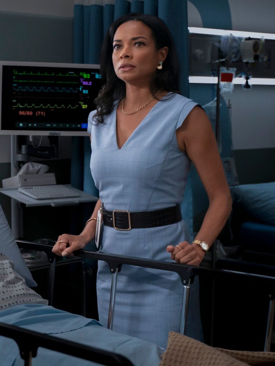 Mary grabs onto the bed and stares at Watson while he examines her mother on Watson Season 2 Episode 1