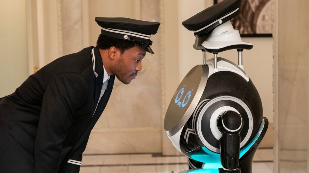 Randall gets on eye level with the robot on Only Murders In The Building Season 5 Episode 9