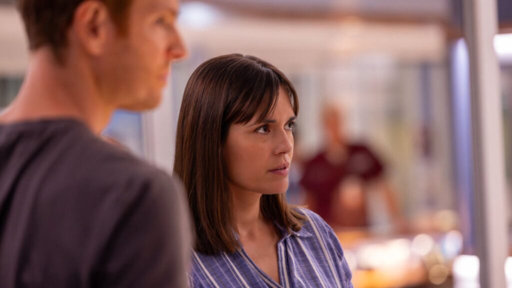 Natalie and Will stare through the observation window on Chicago Med Season 11 Episode 3