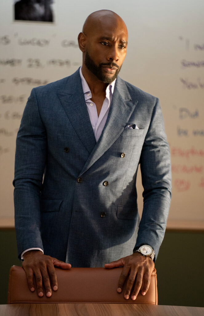 Watson standing by a chair giving instructions on Watson Season 2 Episode 5