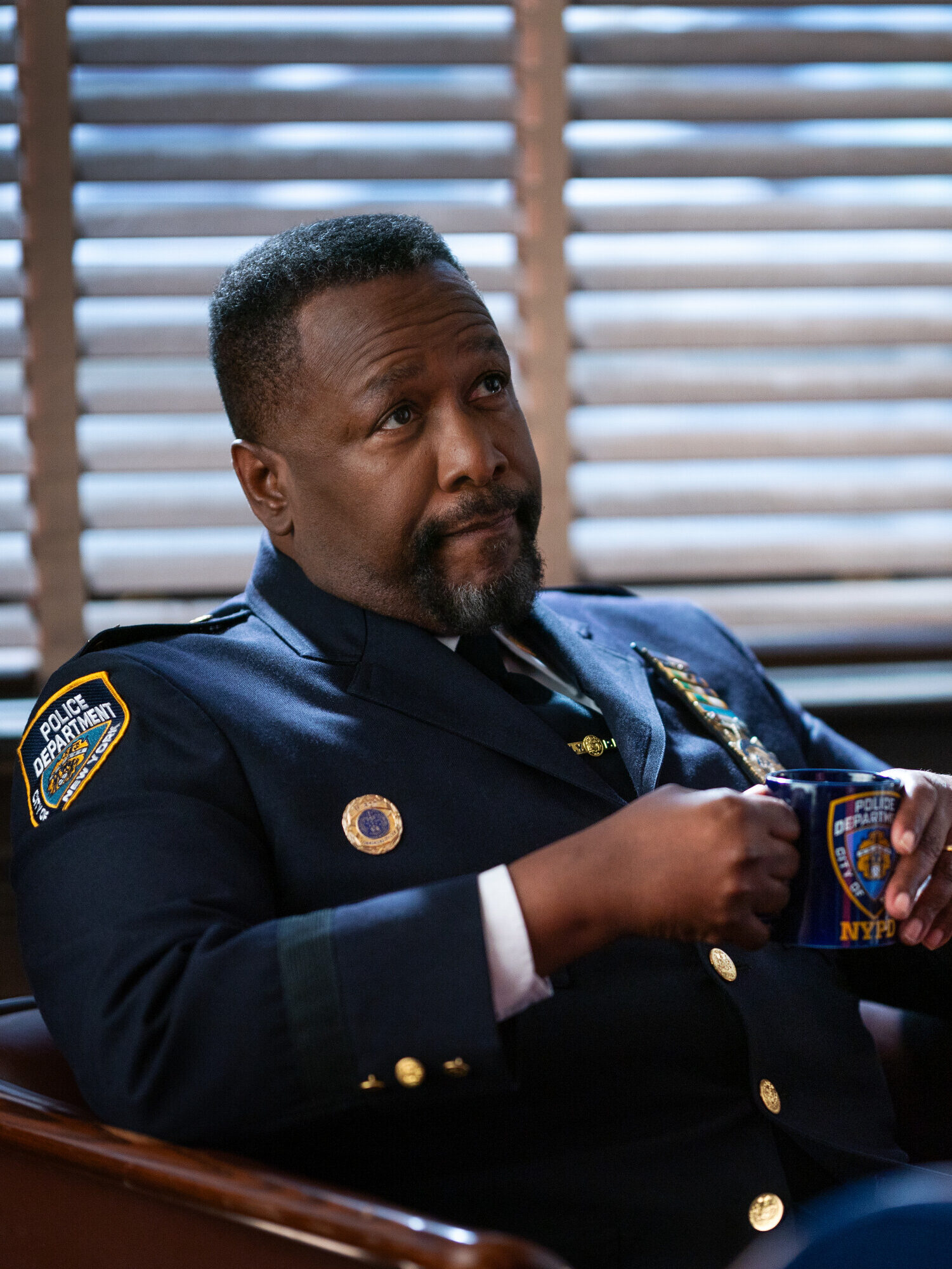 Captain Wagner sits and drinks coffe on Elsbeth Season 3 Episode 5