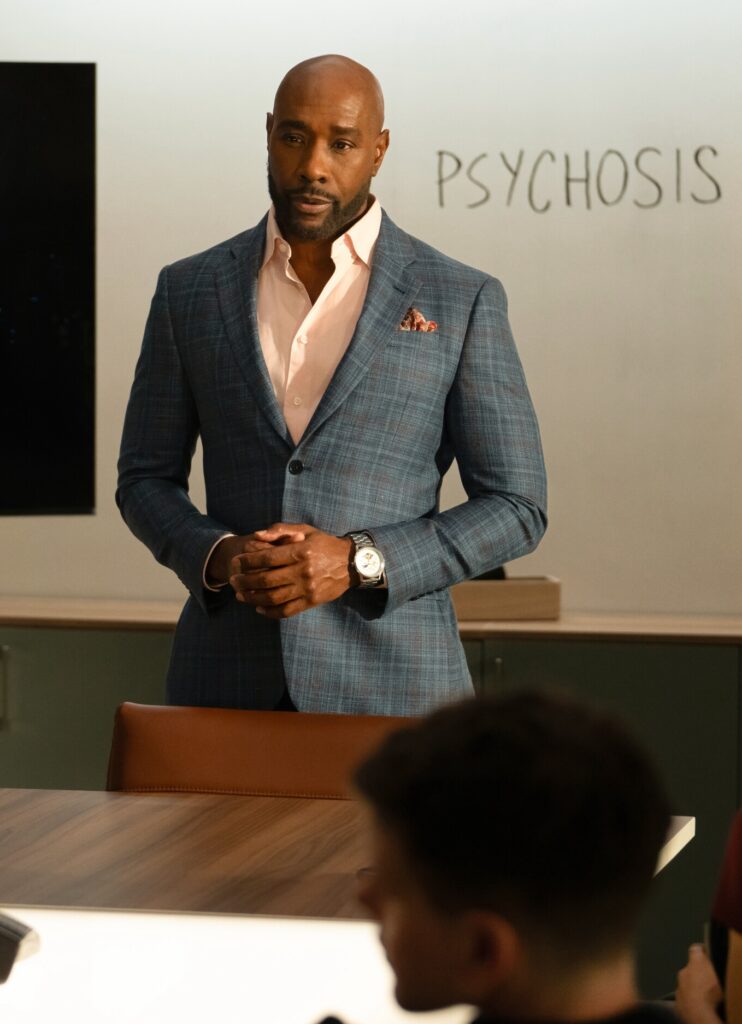 Watson standing next to the word 