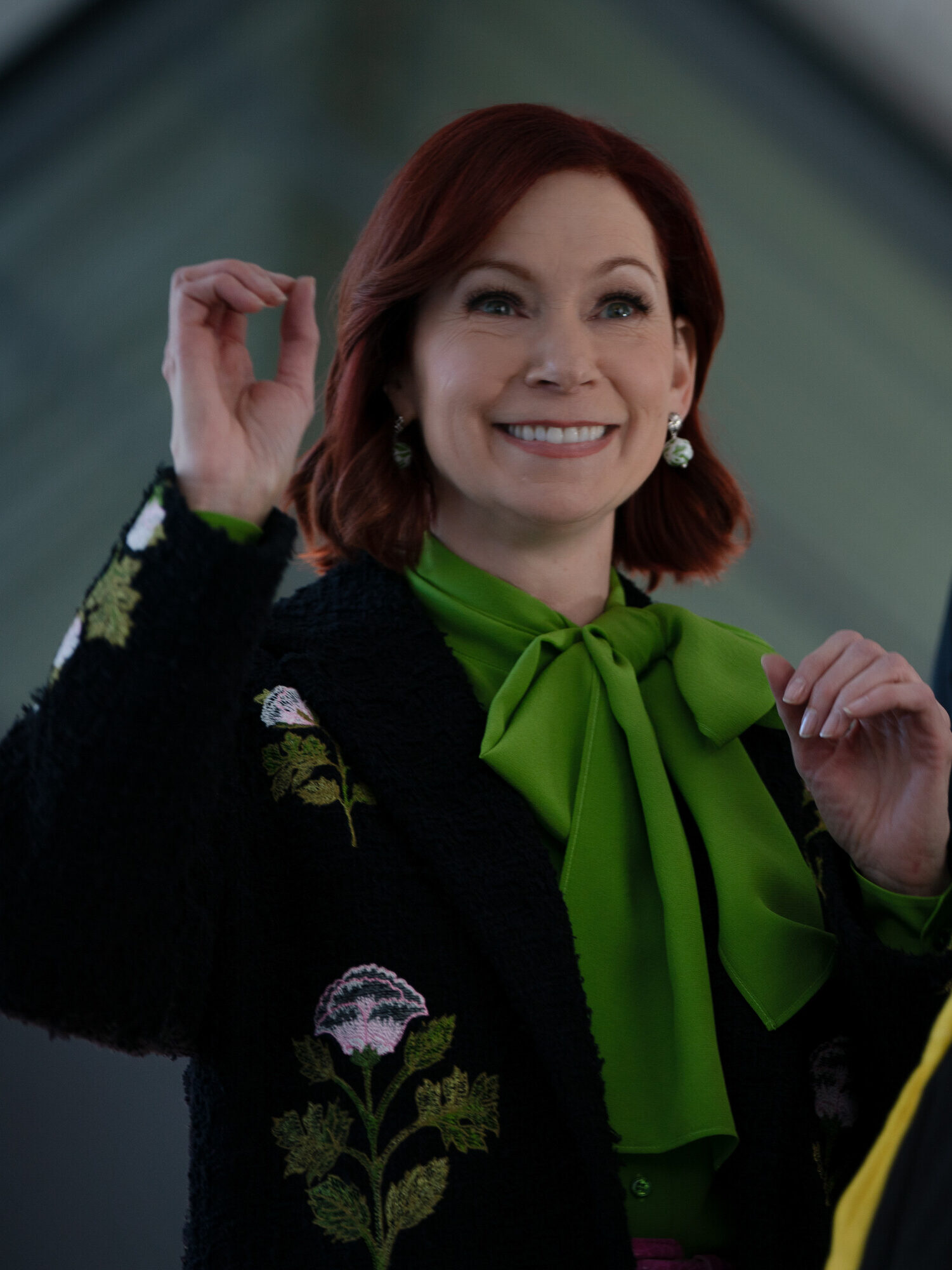 Elsbeth smiling while being escorted out on Elsbeth Season 3 Episode 8