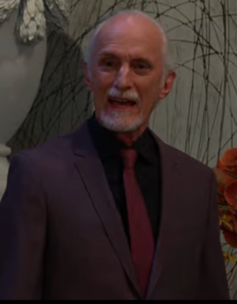 Rolf stands in the DiMera living room, smiling, on Days of Our Lives during the week of 12-08-25