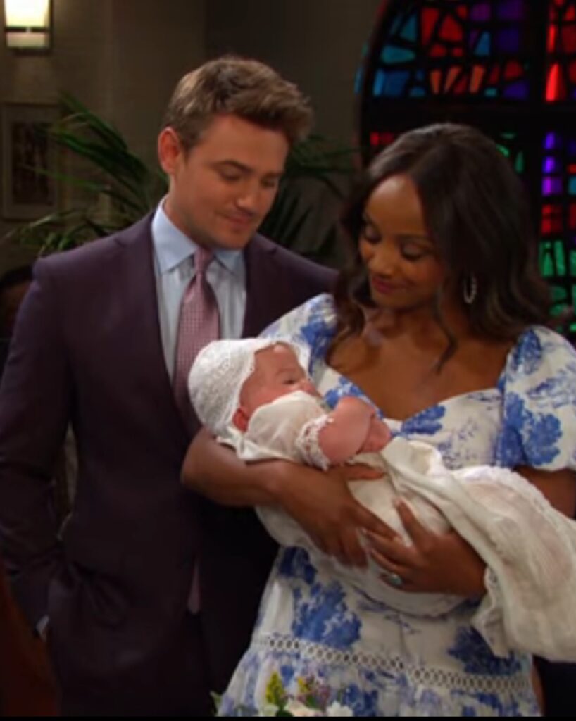 Johnny and Chanel hold their baby during the christening on Days of Our Lives during the week of 1-19-26