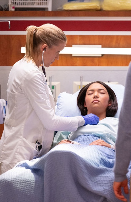 Hannah examines a teenage girl on Chicago Med Season 11 Episode 12