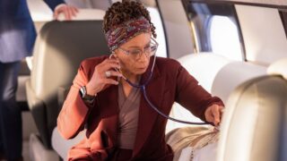 Sharon checks someone's vital signs on a plane on Chicago Med Season 11 Episode 12