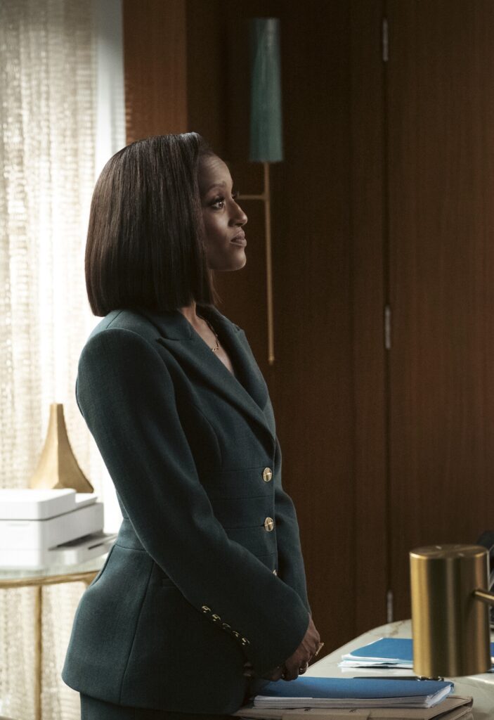 Olympia standing behind her desk on Matlock Season 2 Episode 10