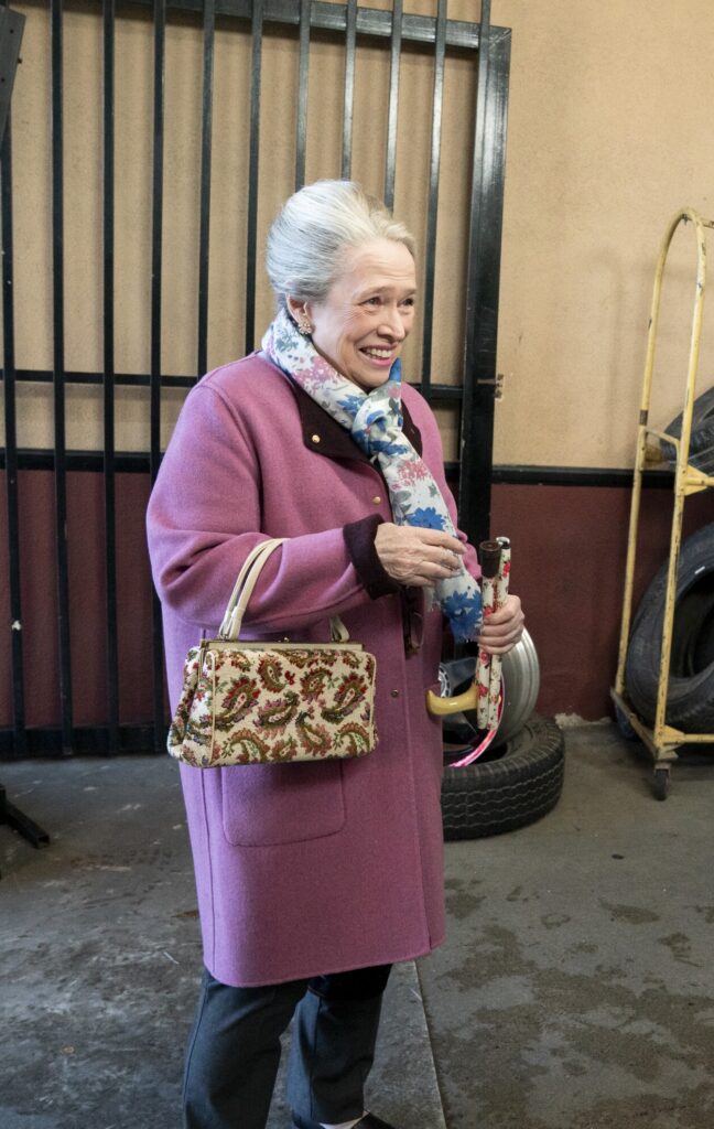 Maddy standing outside and smiling on Matlock Season 2 Episode 11